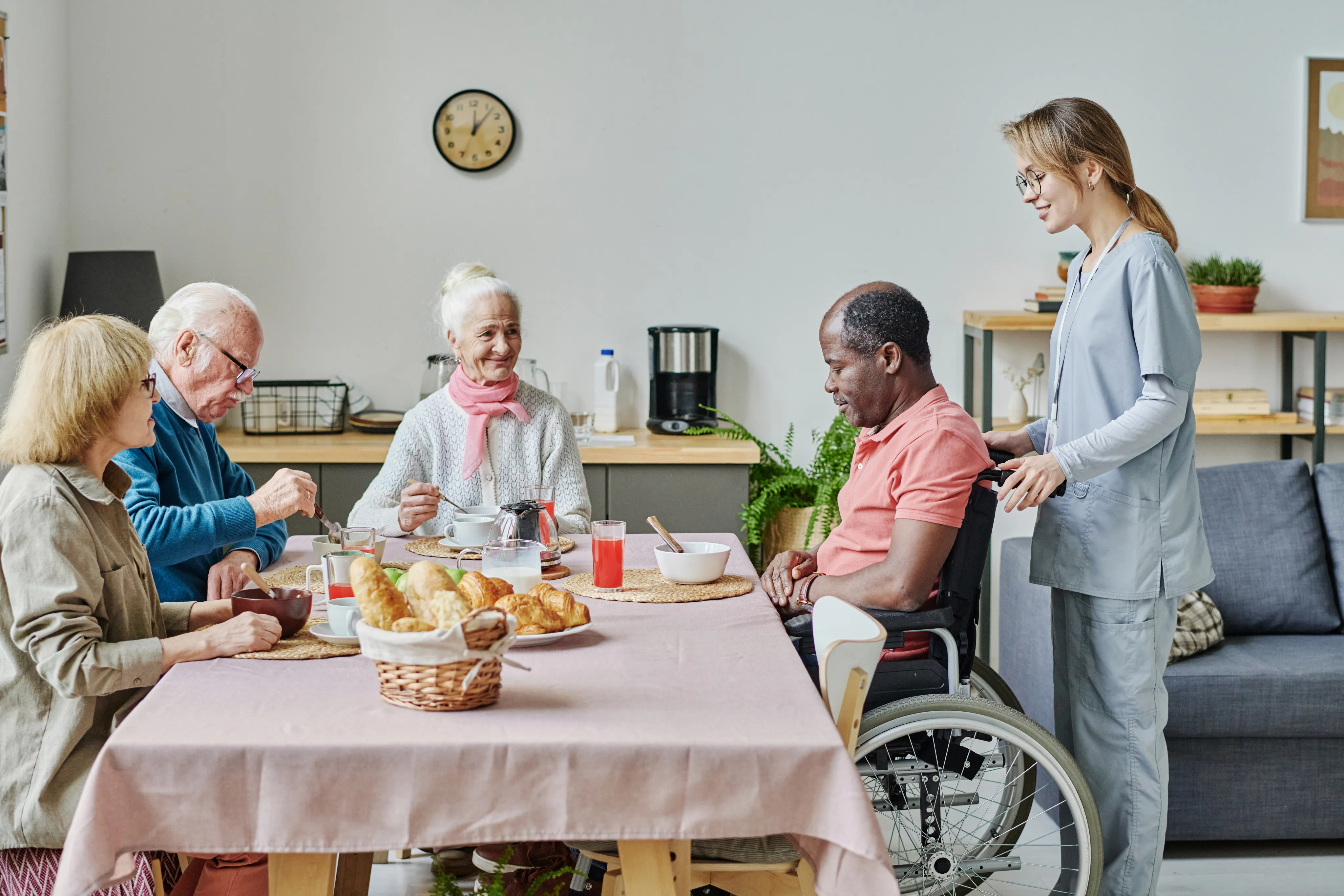 Elderly people having lunch together in a care facility